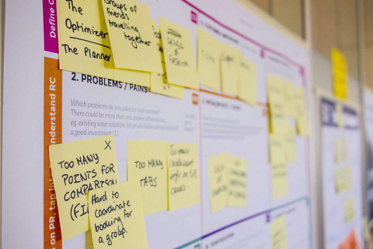 A strategy wall covered in handwritten sticky notes during a planning workshop